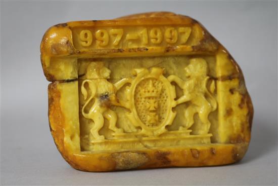 A piece of raw amber carved with the crest of the Polish City of Gdansk with the date 997-1997.